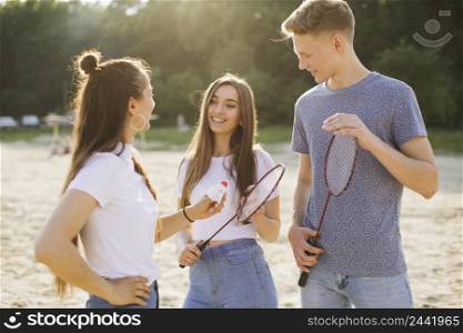 medium shot smiley friends with badminton rackets