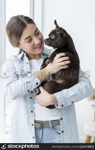 medium shot smiley girl holding cute dog