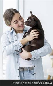 medium shot smiley girl holding cute dog