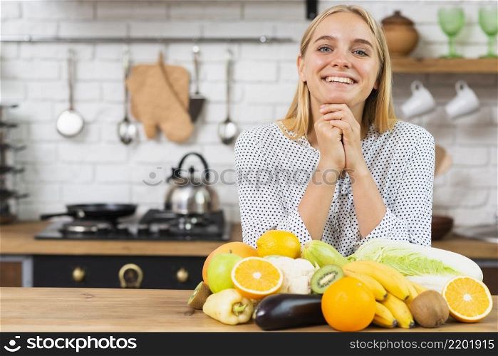 medium shot smiley girl with fruits kitchen