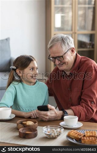 medium shot smiley grandpa girl