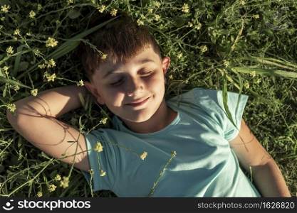 medium shot smiley kid laying grass
