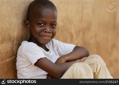 medium shot smiley kid sitting outdoors