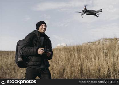 medium shot smiley man controlling drone