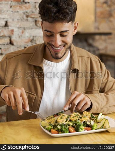 medium shot smiley man eating food