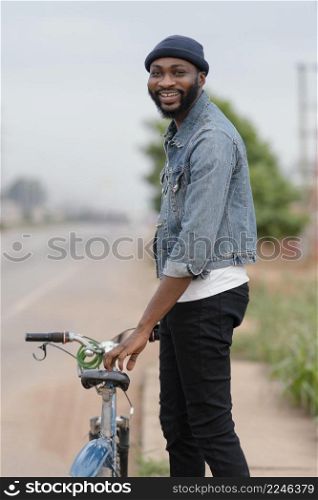 medium shot smiley man holding bicycle