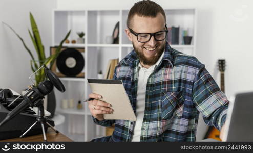 medium shot smiley man holding notebook