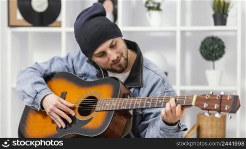 medium shot smiley man playing guitar
