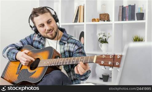 medium shot smiley man playing guitar 3