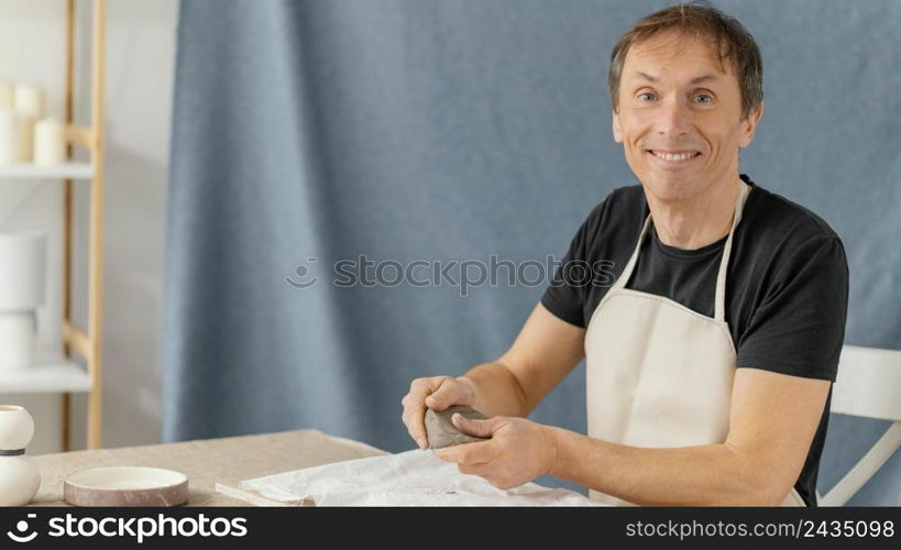 medium shot smiley man with clay home