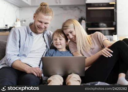 medium shot smiley parents kid with laptop