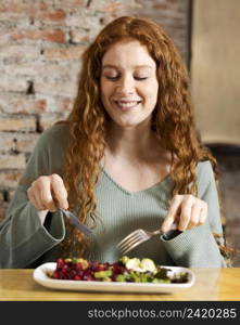 medium shot smiley woman eating