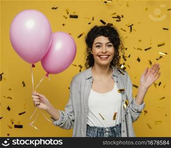 medium shot smiley woman holding balloons