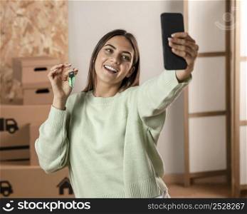 medium shot smiley woman holding phone 2