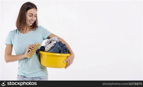 medium shot smiley woman with brush laundry basket