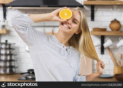 medium shot smiley woman with half orange