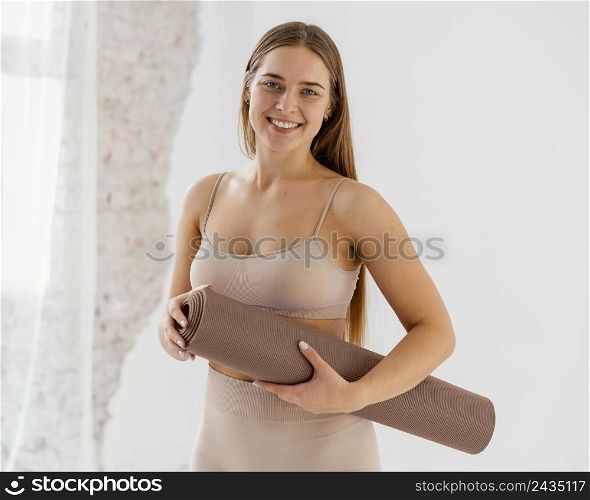 medium shot smiley woman with mat