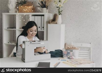 medium shot smiley woman with sewing machine