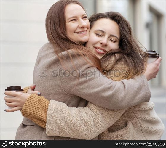 medium shot smiley women hugging