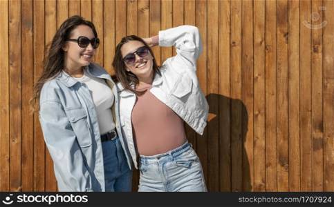 medium shot smiley women with sunglasses