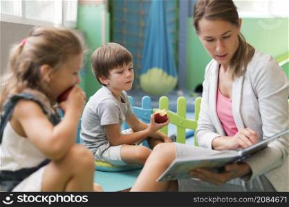 medium shot teacher reading kids
