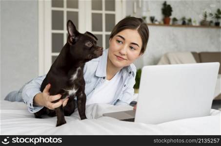 medium shot teen bed with laptop dog