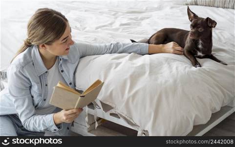 medium shot teenager reading with dog