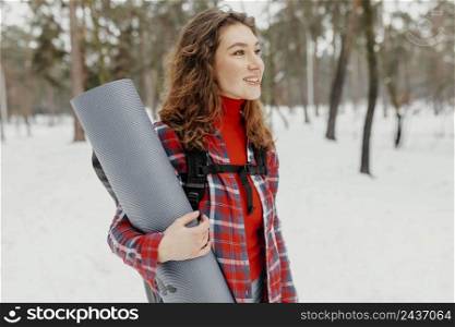medium shot woman carrying mat