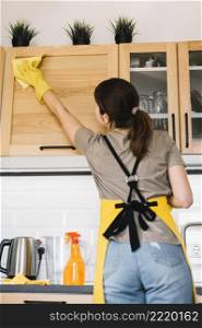 medium shot woman cleaning cabinet