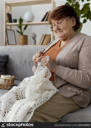 medium shot woman crocheting couch