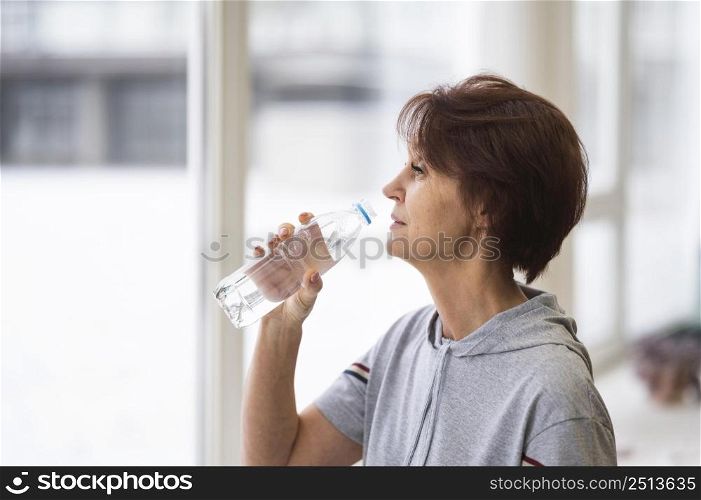 medium shot woman drinking water