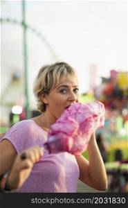 medium shot woman eating cotton candy