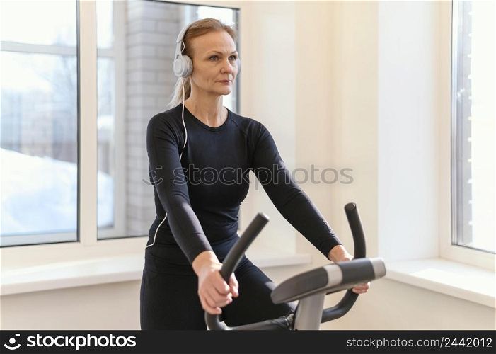 medium shot woman exercising spin bike