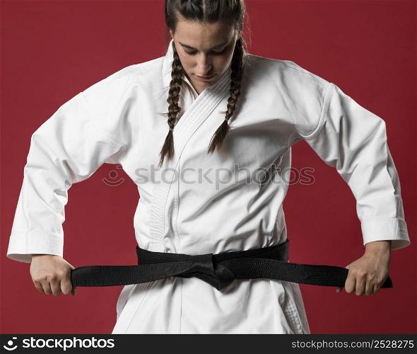 medium shot woman fighter straighten her belt
