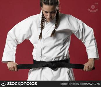 medium shot woman fighter straighten her belt