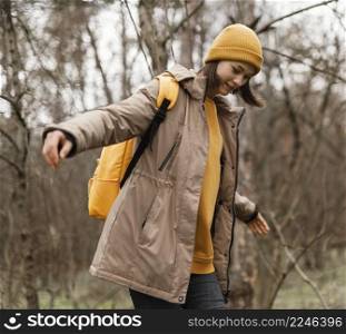 medium shot woman forest hiking