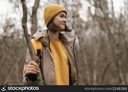 medium shot woman holding branch