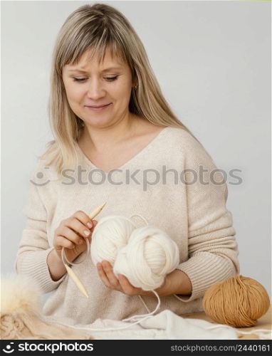 medium shot woman holding cable needle