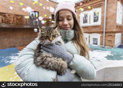 medium shot woman holding cat