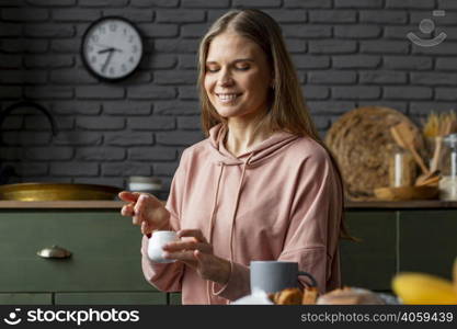 medium shot woman holding cream container