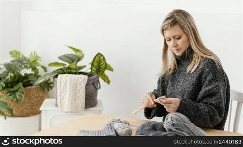 medium shot woman holding knitting needles
