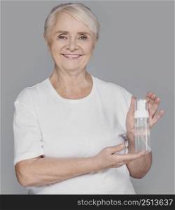 medium shot woman holding serum bottle