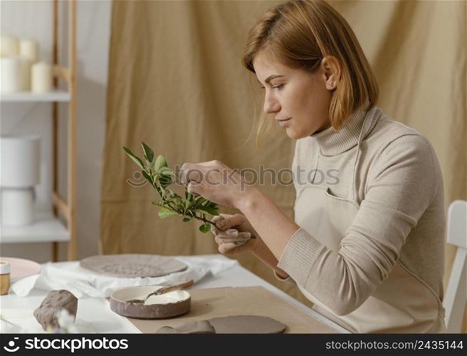 medium shot woman holding twig
