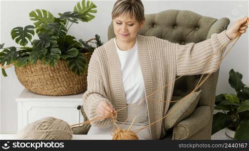 medium shot woman holding yarn