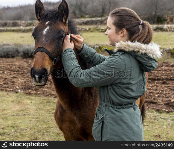 medium shot woman horse outdoors