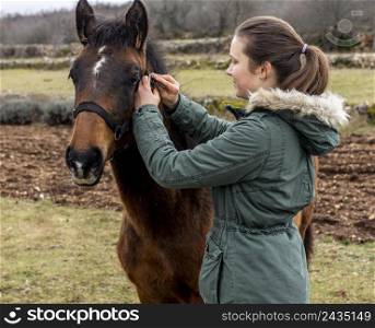 medium shot woman horse outdoors