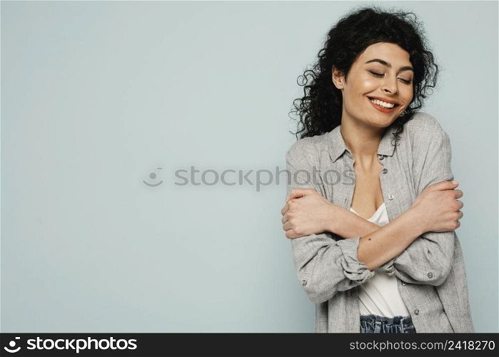 medium shot woman hugging herself