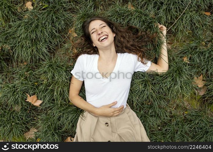 medium shot woman laughing grass