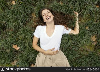 medium shot woman laughing grass