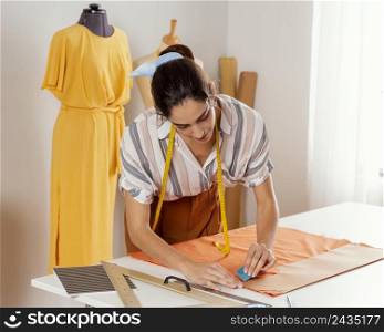 medium shot woman marking fabric